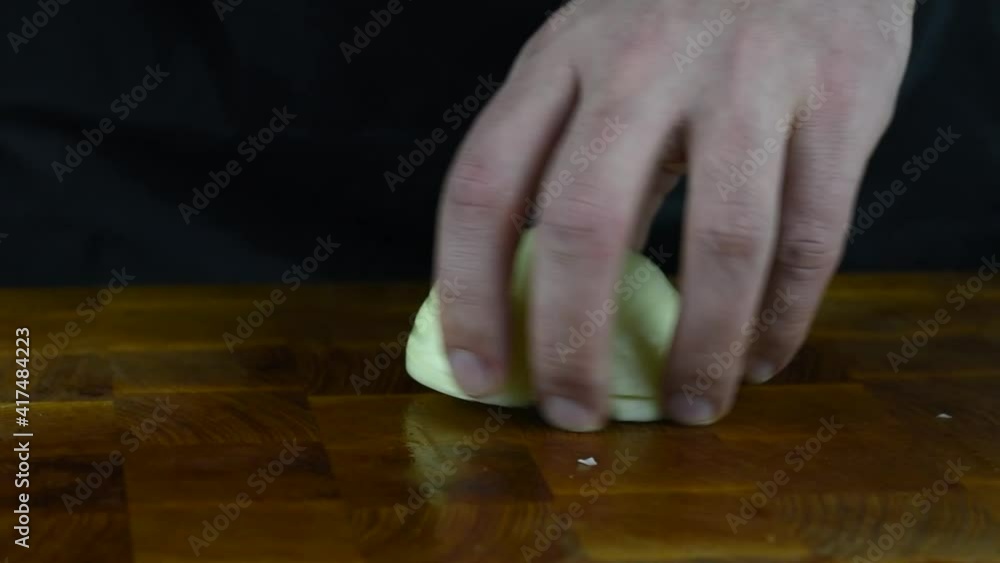 Close up of Chef cook hands chopping vegetables for traditional cuisine with Japanese knife. Professional chef cutting onion on wooden board. Close up of Chef cook hands chopping vegetables for traditional cuisine with Japanese knife. Professional chef cutting onion on wooden board.