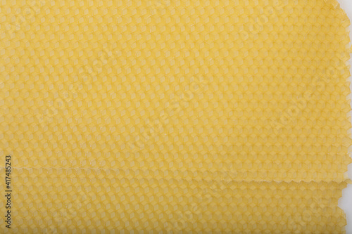 Yellow empty bees wax background with cells in close up