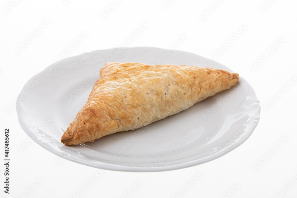 Crispy chicken patty triangle shape on white plate Crispy chicken patty triangle shape on white plate