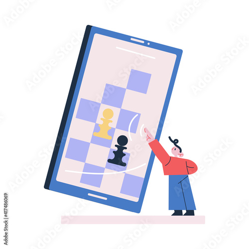 Young boy standing playing chess online on huge tablet