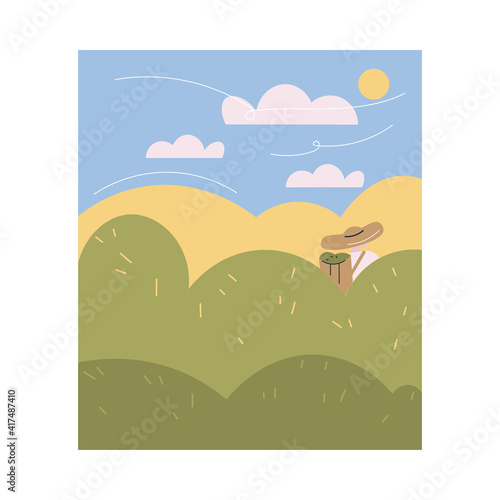 Worker in uniform and hat carrying basket with fresh tea leaves after picking