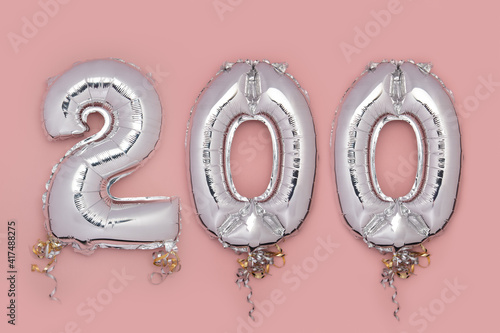 Balloon Bunting for celebration Happy 200th Anniversary made from Silver Number Balloons on pink background. Holiday Party Decoration or postcard concept with top view photo