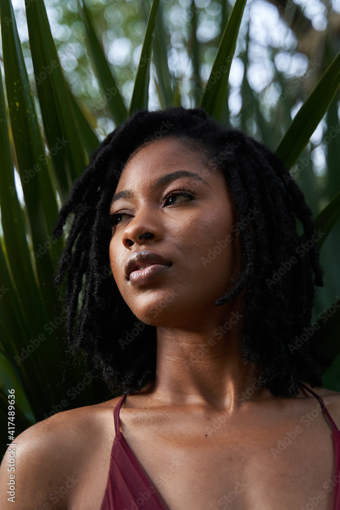 Portrait of confident African American woman with plants Portrait of confident African American woman with plants