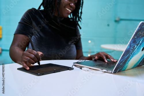 Black graphic design artist creative working on school project, on laptop