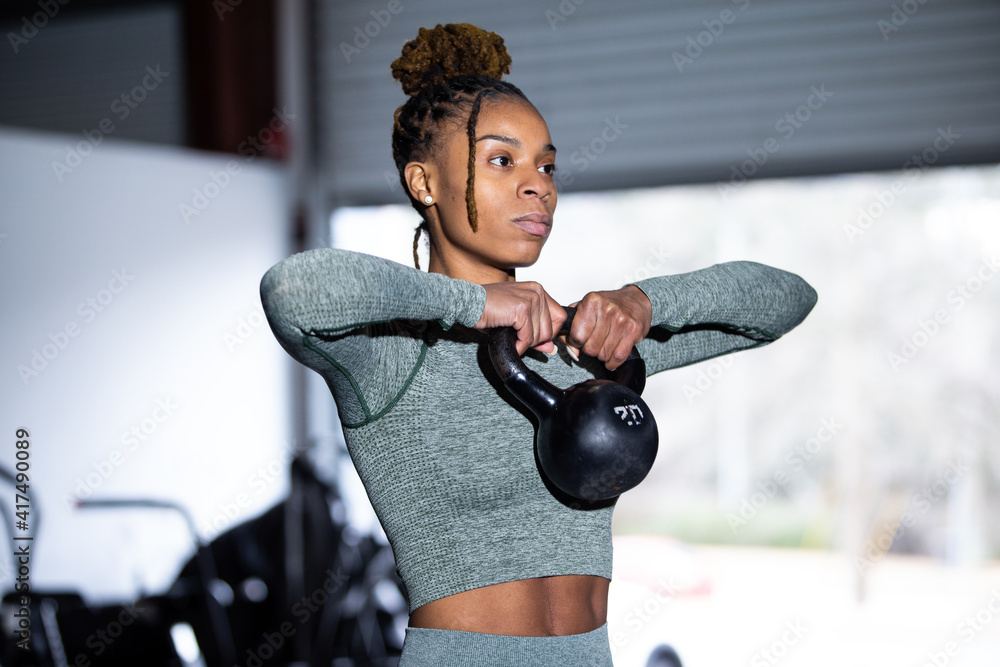 Black woman does fitness workout kettlebell upright row Stock Photo Adobe Stock