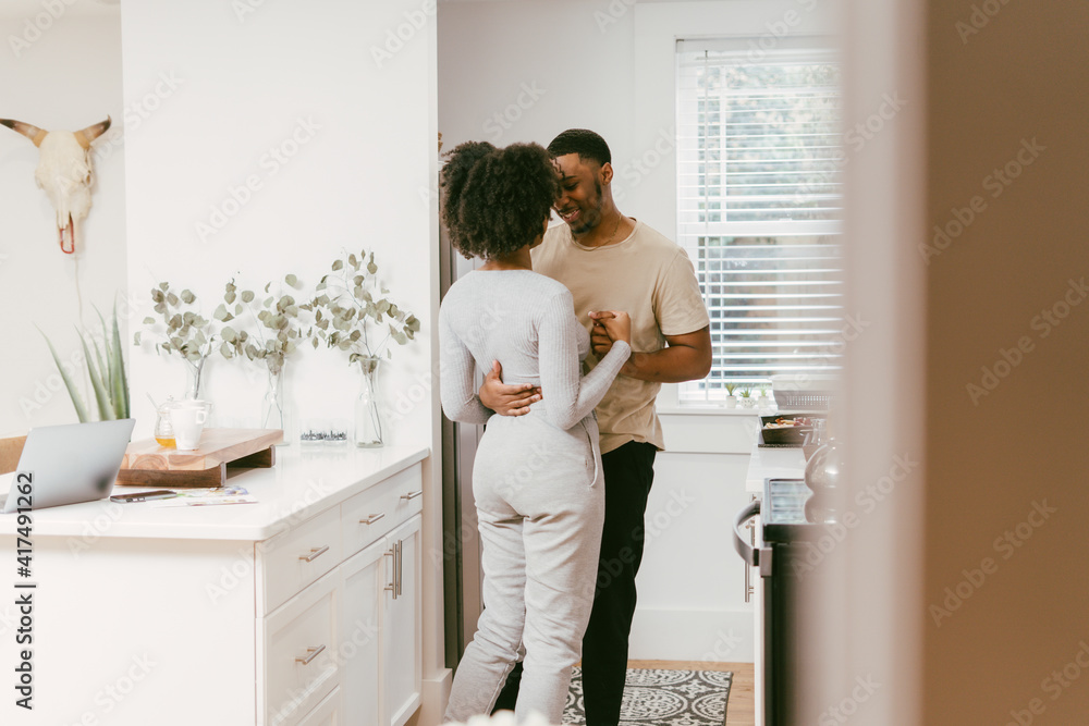 Black couple dancing in kitchen at home, intimate moment Black couple dancing in kitchen at home, intimate moment