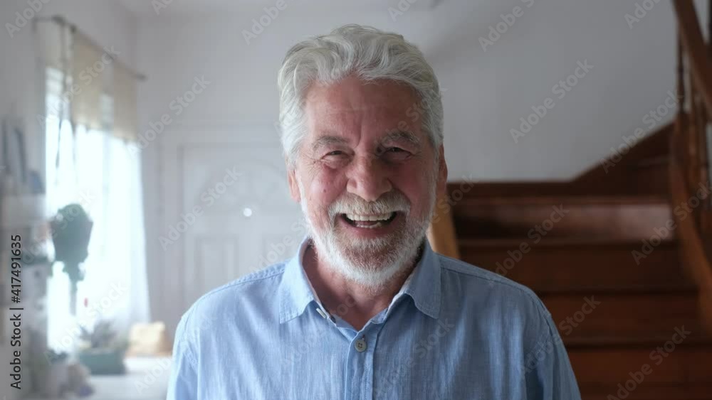 Portrait of old man smiling and looking at the camera sitting on the sofa from home. Closeup male person senior cheerful indoor.
Portrait of old man smiling and looking at the camera sitting on the sofa from home. Closeup male person senior cheerful indoor.