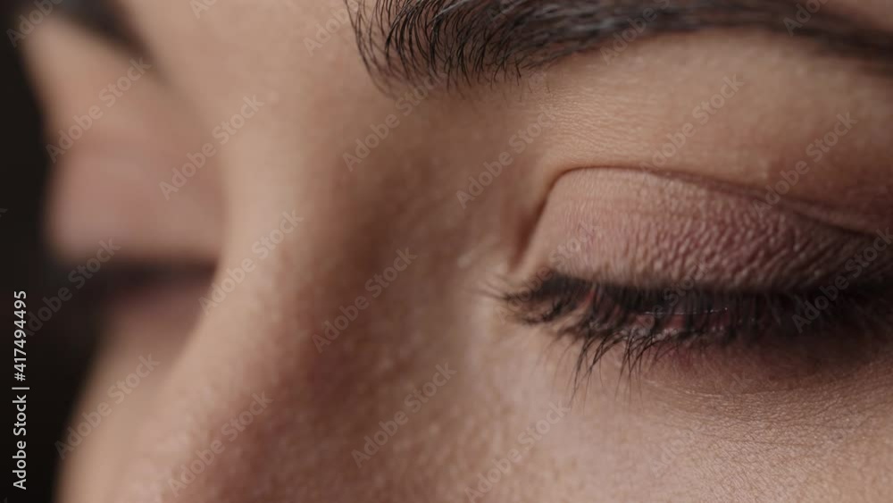 Close up macro zoom shot of eyes. Slow motion. Attractive brunette girl with beautiful face. Young woman eyes opening while looking at Camera, having long nice Eyelashes. Caucasian woman face. Close up macro zoom shot of eyes. Slow motion. Attractive brunette girl with beautiful face. Young woman eyes opening while looking at Camera, having long nice Eyelashes. Caucasian woman face.