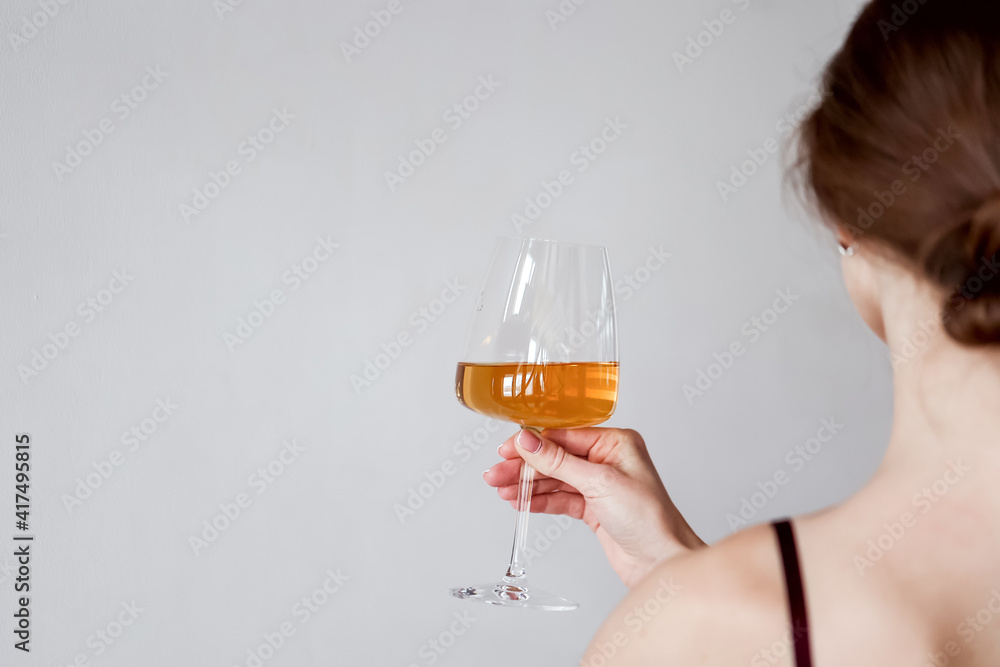 Back view woman holding tasting wine Back view woman holding tasting wine