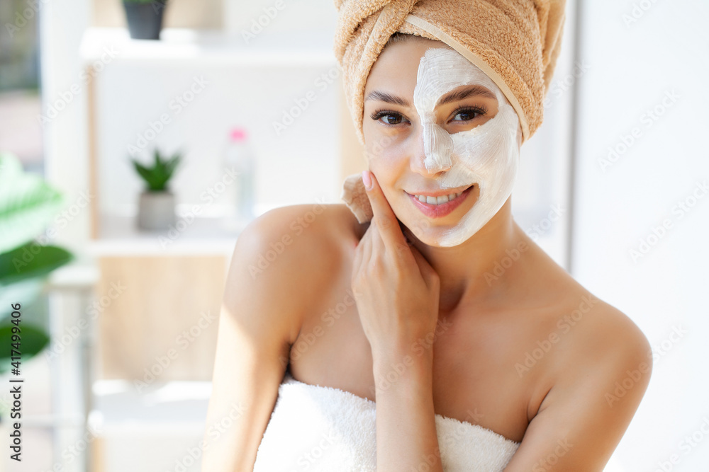 Skin care, woman with beautiful facial skin applying mask on face Skin care, woman with beautiful facial skin applying mask on face