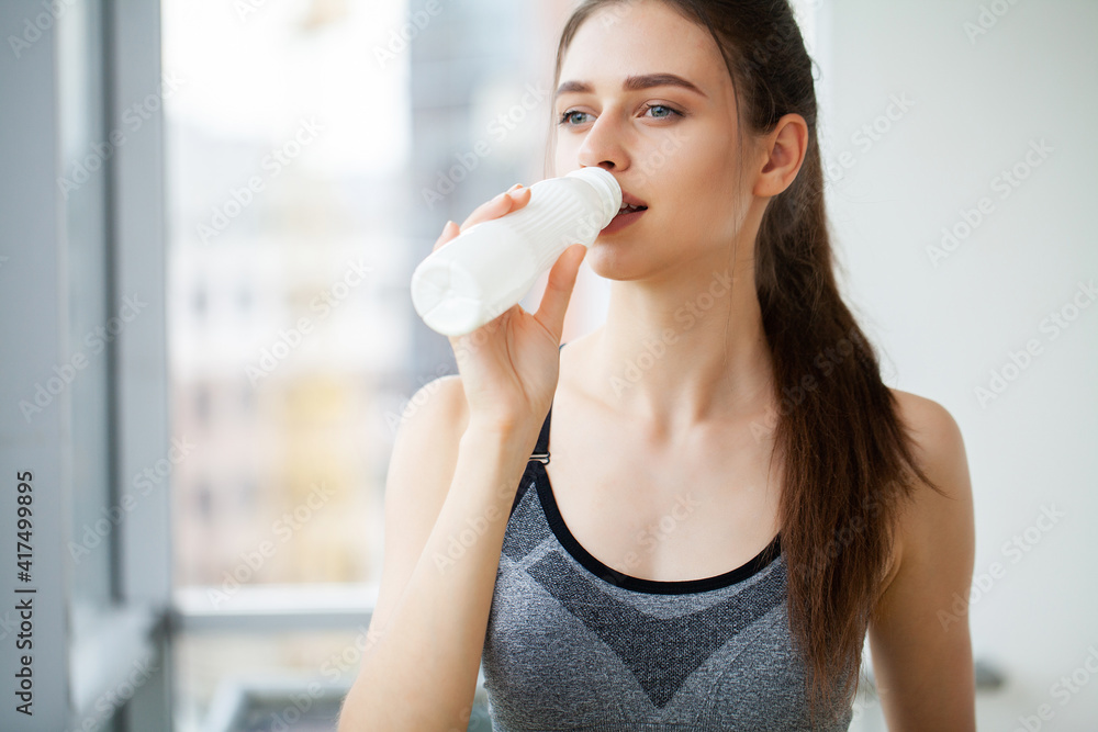Young beautiful woman drinking from plastic bottle of yogurt Young beautiful woman drinking from plastic bottle of yogurt