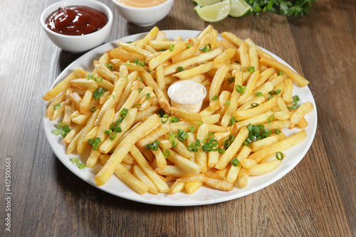 Portion of fries.Portion of fries. Lettuce, potato, green onion, tomato, ketchup and mayonnaise Lettuce, green onion, tomato, ketchup and mayonnaise