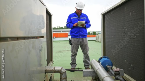 Engineer check equipment of AHU Air housing unit and record result to notebook