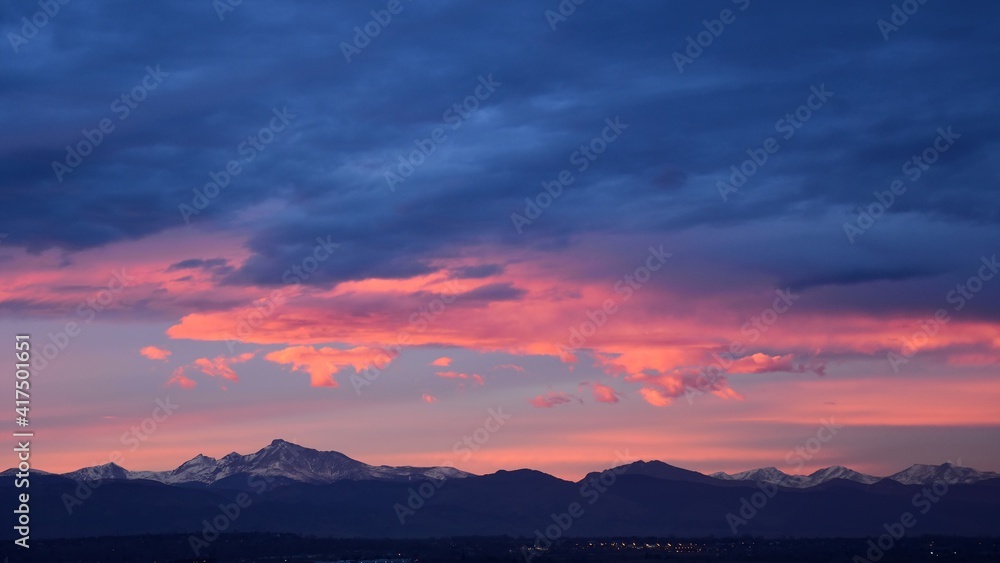 Fototapeta premium dramatic sunset over long's peak and the front range of the colorado rocky mountains as seen from broomfield, colorado