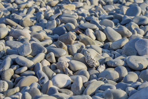 Pebbles in the evening sun on the beach in the city of Nice in France.