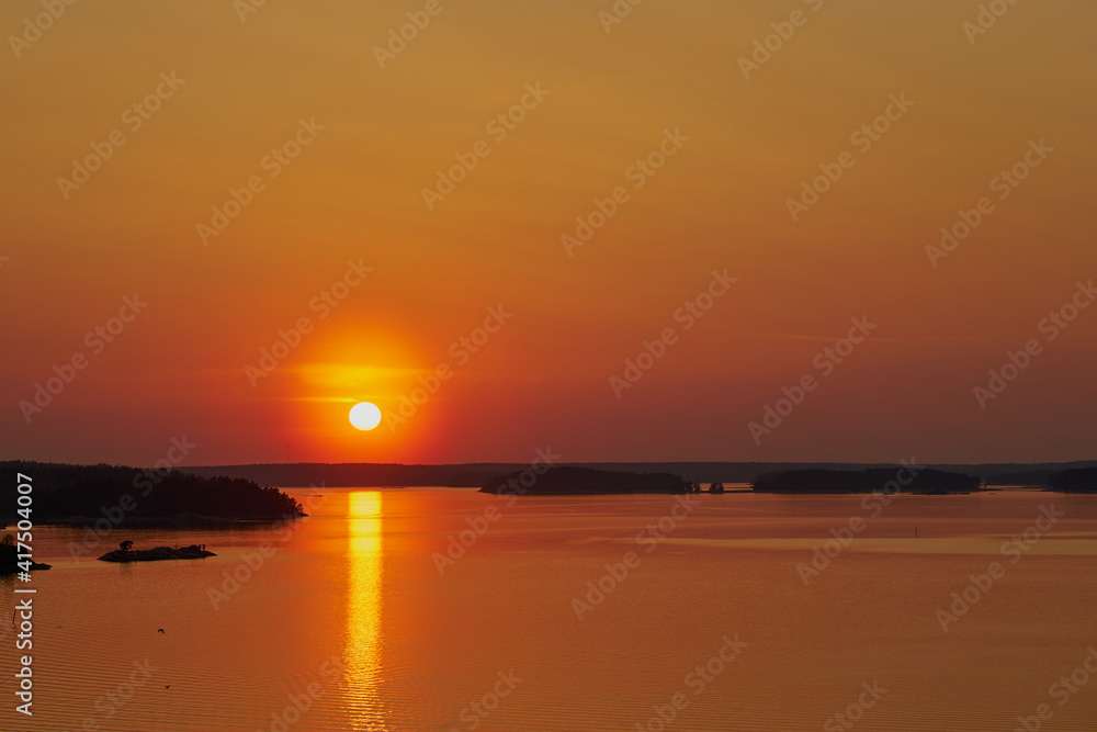Golden sunset in Naantali, Finland. Reflecton of the sun on the water.