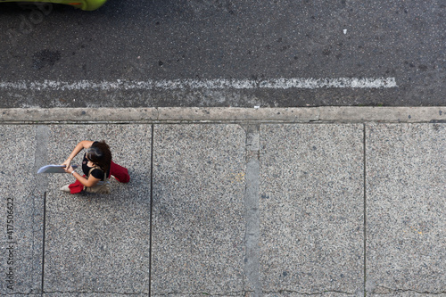 person on the street walking on the sidewalk top view