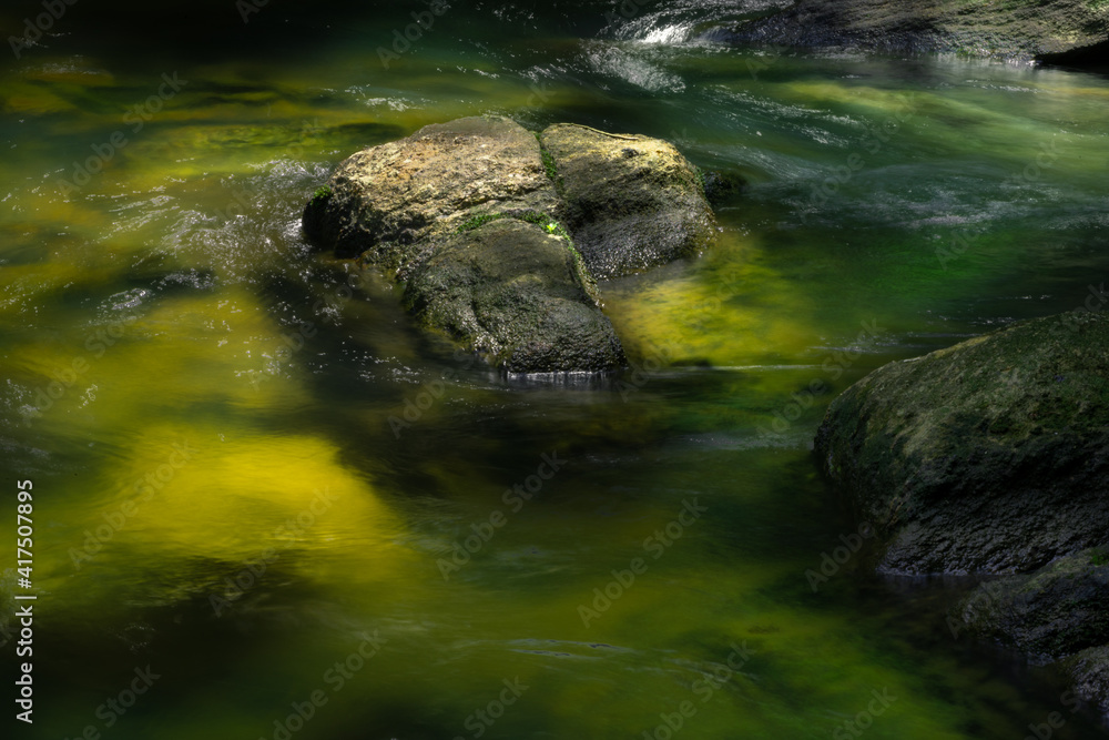 Small water stream and rocks in Bambarawana, light passing through the water and hits the green mossy bottom and glow, long exposure water flowing photograph, Small water stream and rocks in Bambarawana, light passing through the water and hits the green mossy bottom and glow, long exposure water flowing photograph,