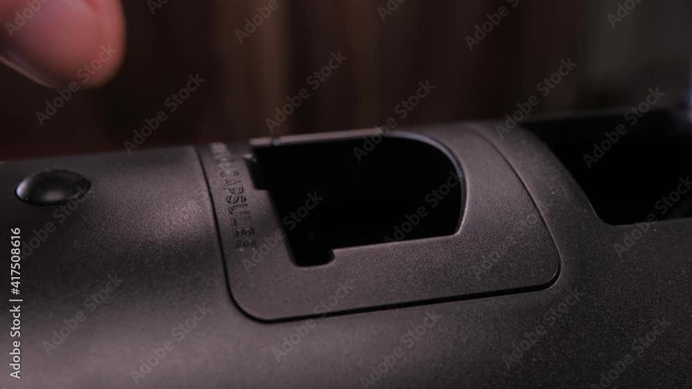 putting capsule into coffee machine putting capsule into coffee machine