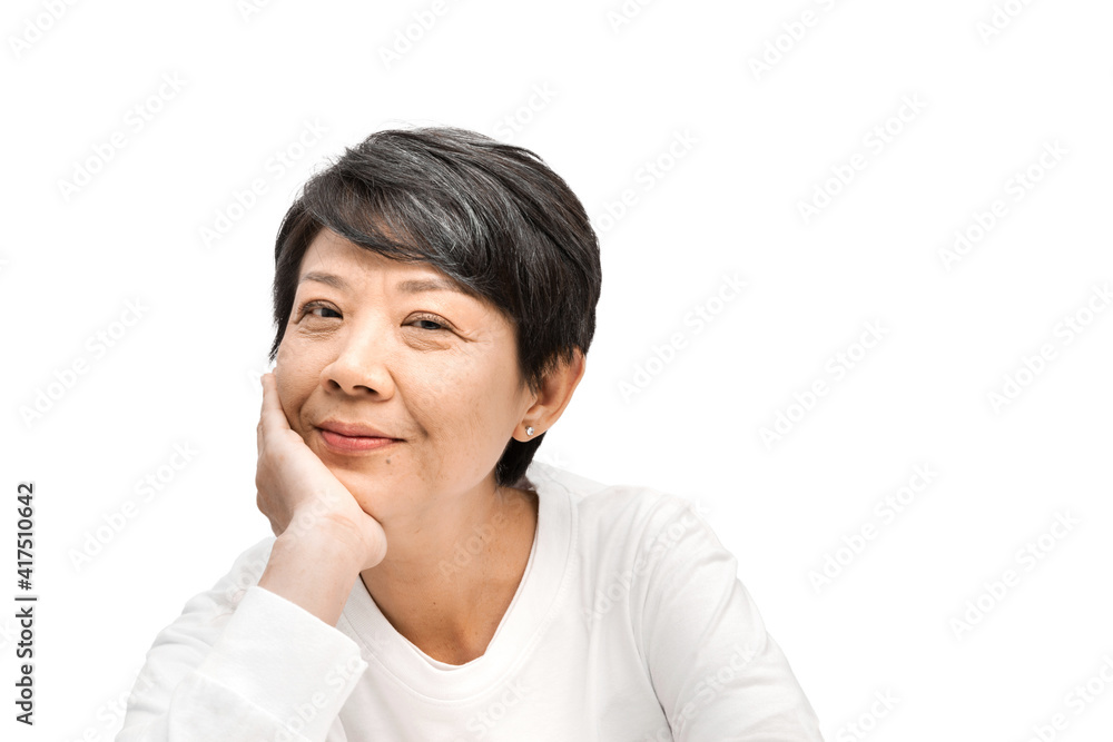 A middle-aged gray-haired Asian woman puts her hand under her chin. And she looks at the camera while smiling, thinking about an idea of the future on a white background, a Beautiful elderly concept. A middle-aged gray-haired Asian woman puts her hand under her chin. And she looks at the camera while smiling, thinking about an idea of the future on a white background, a Beautiful elderly concept.