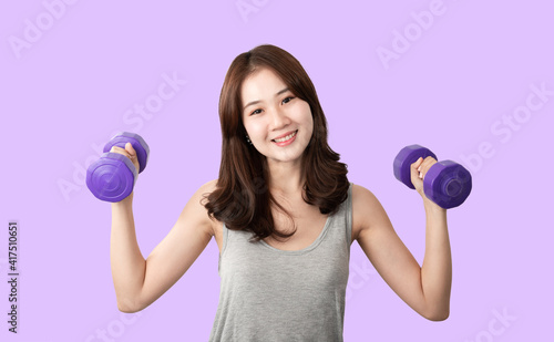 Front view of an Attractive smile young active Asian woman training, exercising, workout at home with lifting weights dumbbells isolated on white background. Fitness Gym Strong healthy Concept