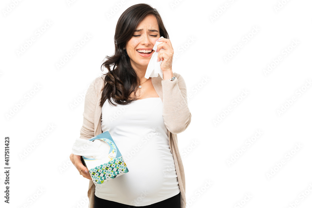 Pregnant woman crying hard and cleaning her face Pregnant woman crying hard and cleaning her face