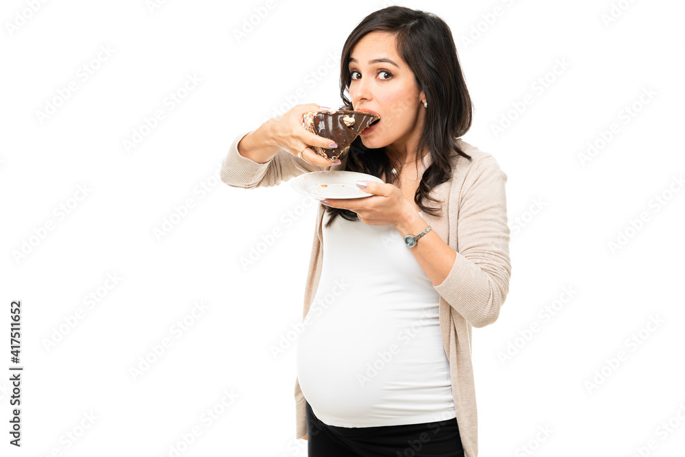 Expectant mother with sugar cravings eating cake Expectant mother with sugar cravings eating cake
