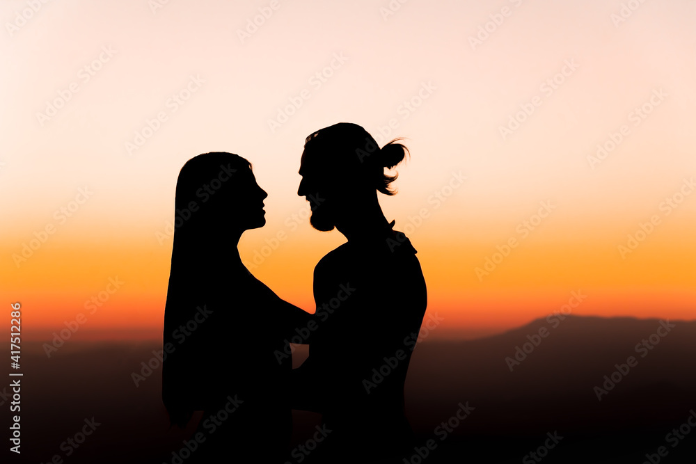 sunset with a silhouette of a couple in love 