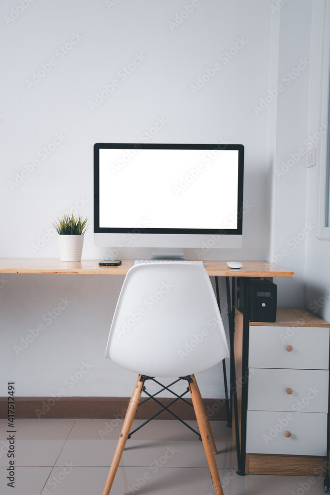 Computer monitor with white blank screen on the business desk with wireless mouse, keyboard at home office over white wall background, Photo of equipment contemporary workspace Computer monitor with white blank screen on the business desk with wireless mouse, keyboard at home office over white wall background, Photo of equipment contemporary workspace