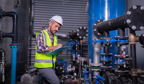 Foto Industry engineer worker wearing safety uniform under checking the industry cooling tower air conditioner is water cooling tower air chiller HVAC of large industrial building to control air system