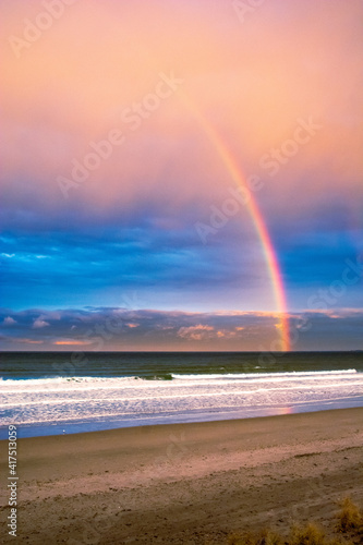 Rainbow over the ocean at sunset