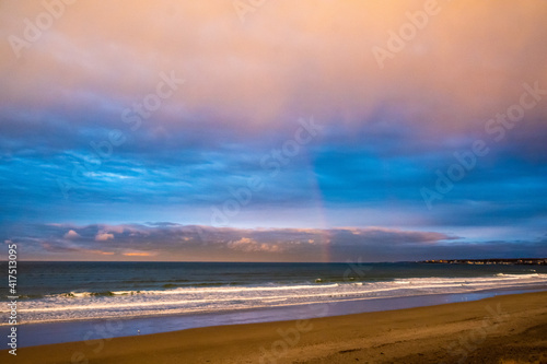 Rainbow over the ocean at sunset