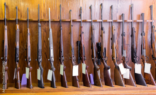 Obraz na plátně Gun store interior with specialized rifles on showcase