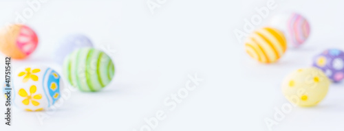 blurred colorful eggs on white background with copy space for Happy Easter day