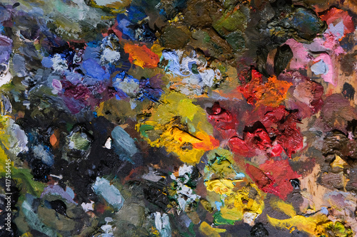 Background of an artist's palette with mixed dried acrylic paints. An abstract artwork. 