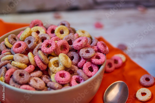 bad breakfast of colorful cereals full of sugar with red fruit juice
