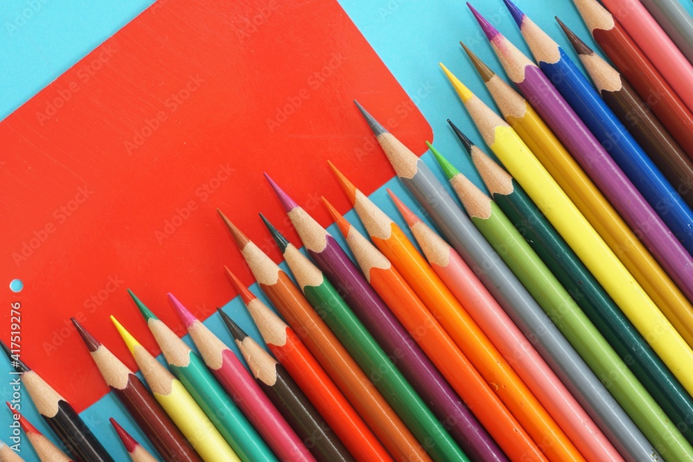 Fototapeta premium colored pencils on blue background