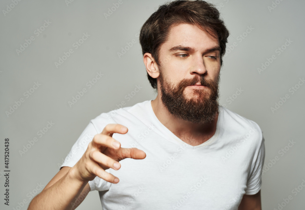 emotional man gesturing with his hands on a light background aggression scream emotional man gesturing with his hands on a light background aggression scream