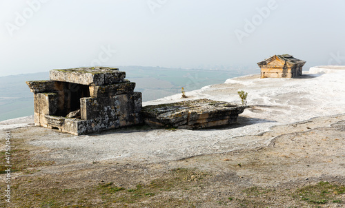 Remains of preserved tombs on white travertine formations in ancient city of Hierapolis, Phrygia, Turkey