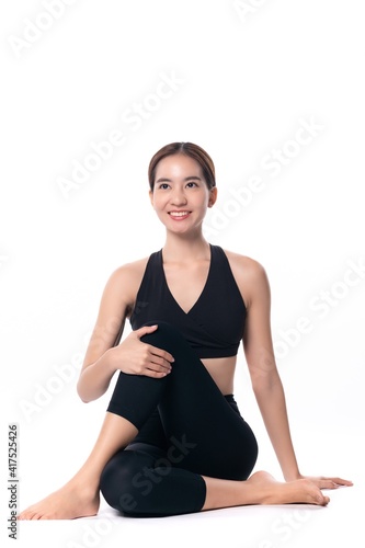 Beautiful sporty woman doing advanced yoga practice on white bac