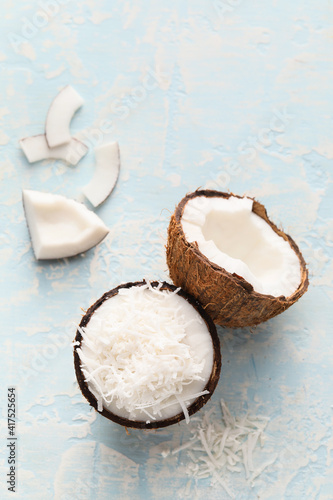 Coconut with flakes on light background