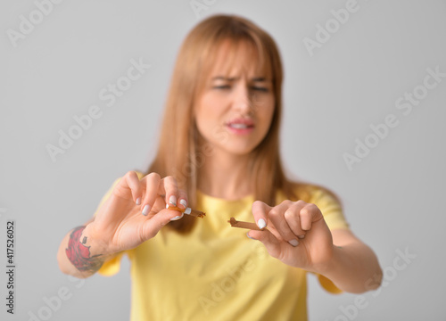 Young woman with broken cig...