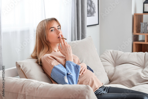 Pregnant woman smoking at home
