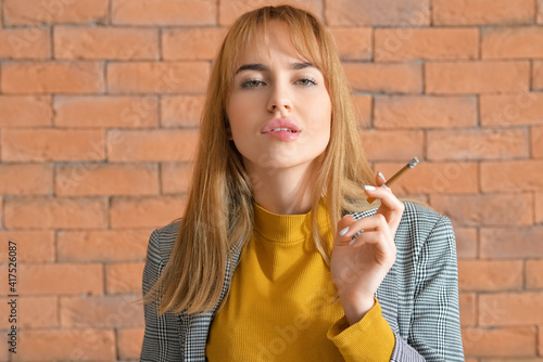 Young woman with cigarette ...