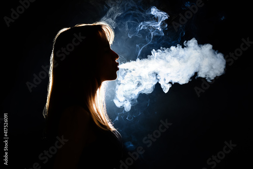 Silhouette of smoking young...