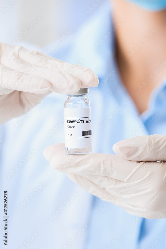 Scientist with vaccine against COVID-19 in laboratory, closeup Scientist with vaccine against COVID-19 in laboratory, closeup