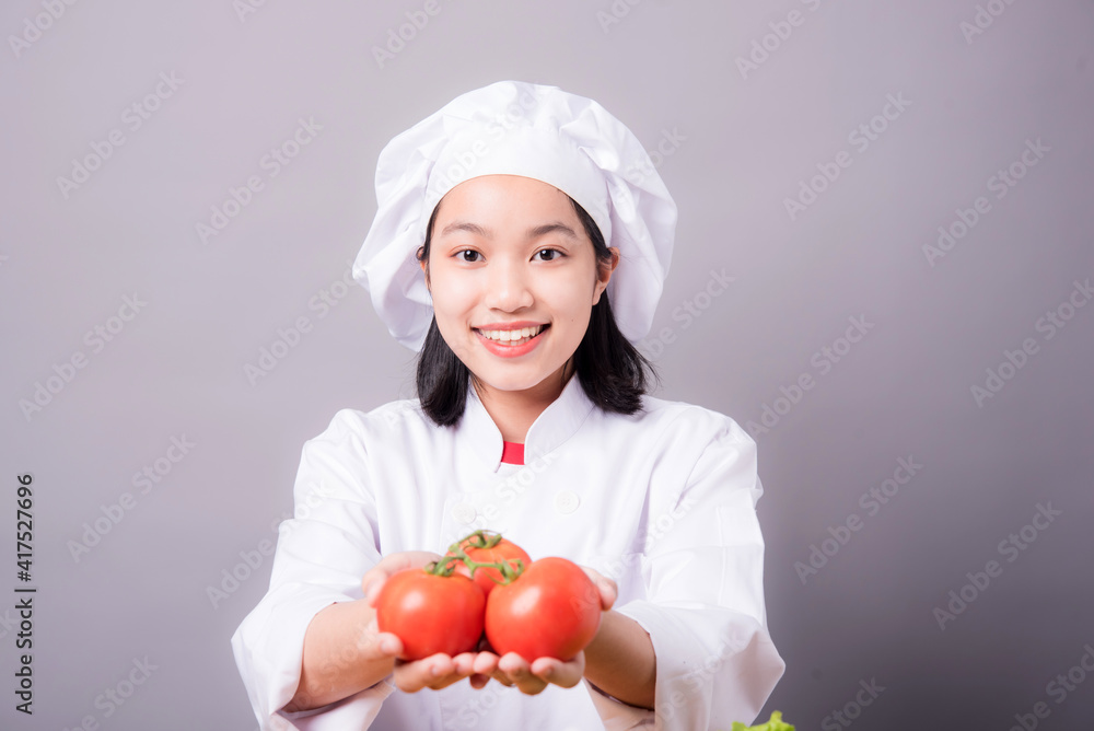 Portrait of a young Asian female chef ready to cook a new dish in the kitchen. Portrait of a young Asian female chef ready to cook a new dish in the kitchen.