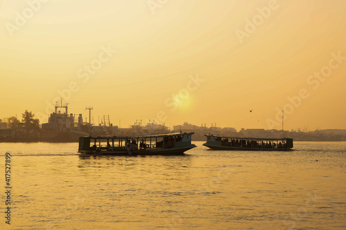 Two passenger ships crossed the river between the sun
