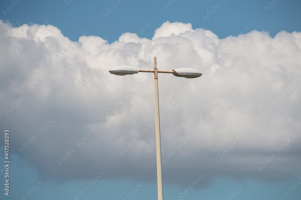 Double Street Lamp Against Heavy Cloudy Sky Double Street Lamp Against Heavy Cloudy Sky