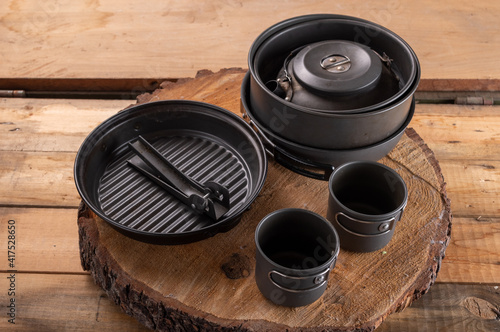 Compact travel tableware that folds one into one. Aluminum bowl and mugs. photo